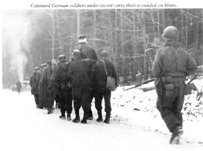 German POWs being escorted to the rear.